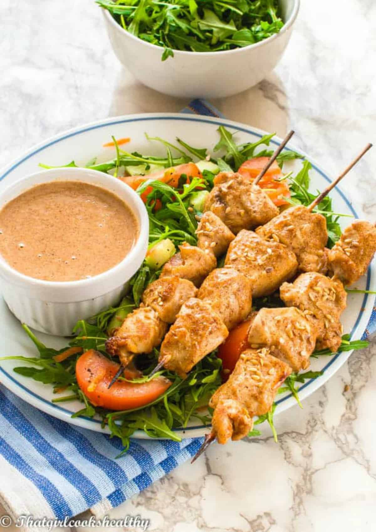 skewers on a bed of leafy greens