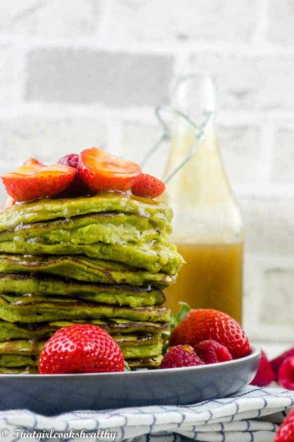 A stack of pancakes with fruit on top