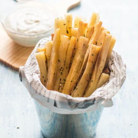 Yucca fries in chip holder with dip in the background