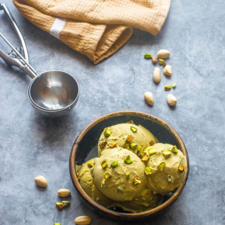Vegan pistachio ice cream Vegan pistachio ice cream in a bowl with scoop