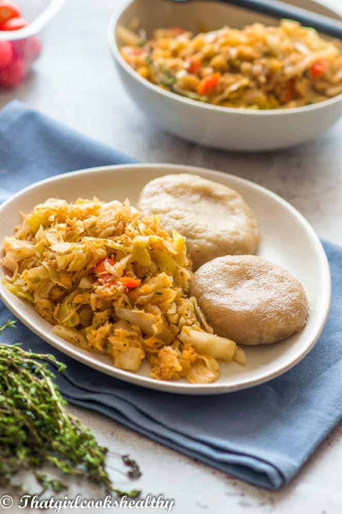 Saltfish. cabbage with two dumplings on a cloth