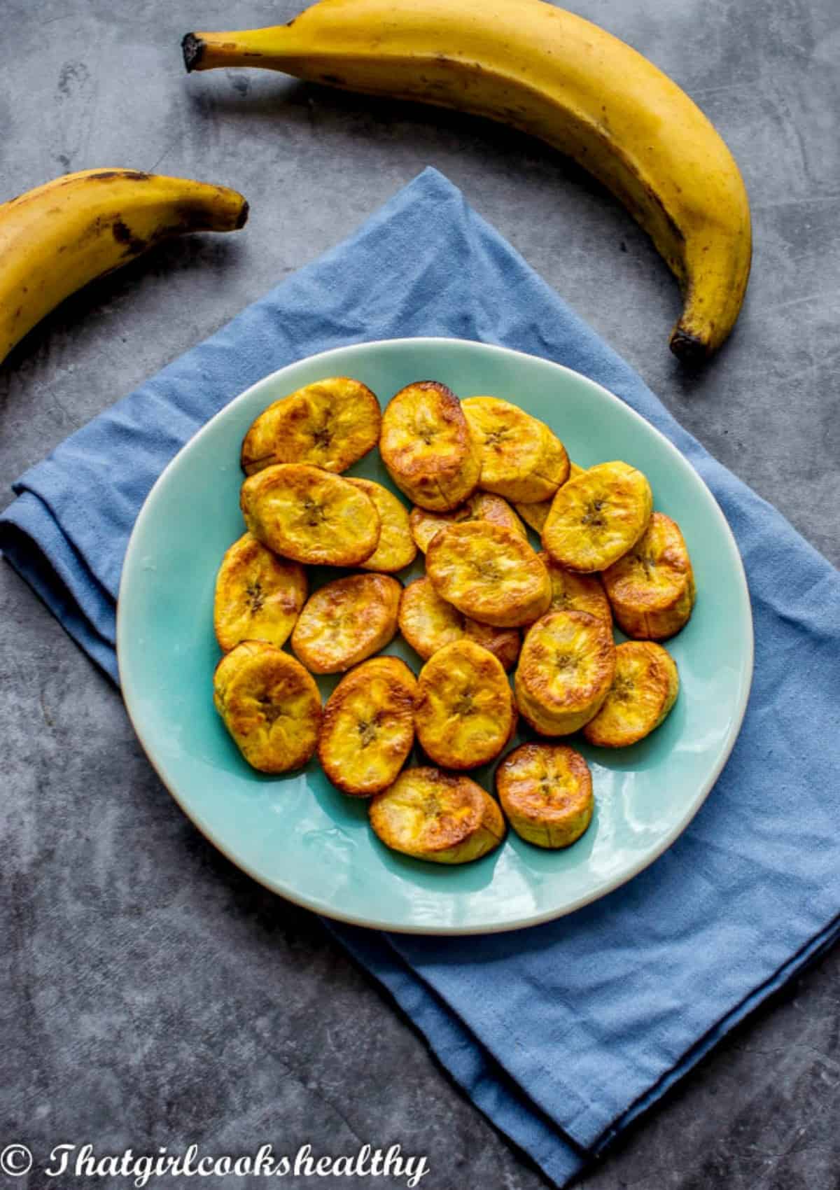 plantain slices on a plate with blue clo