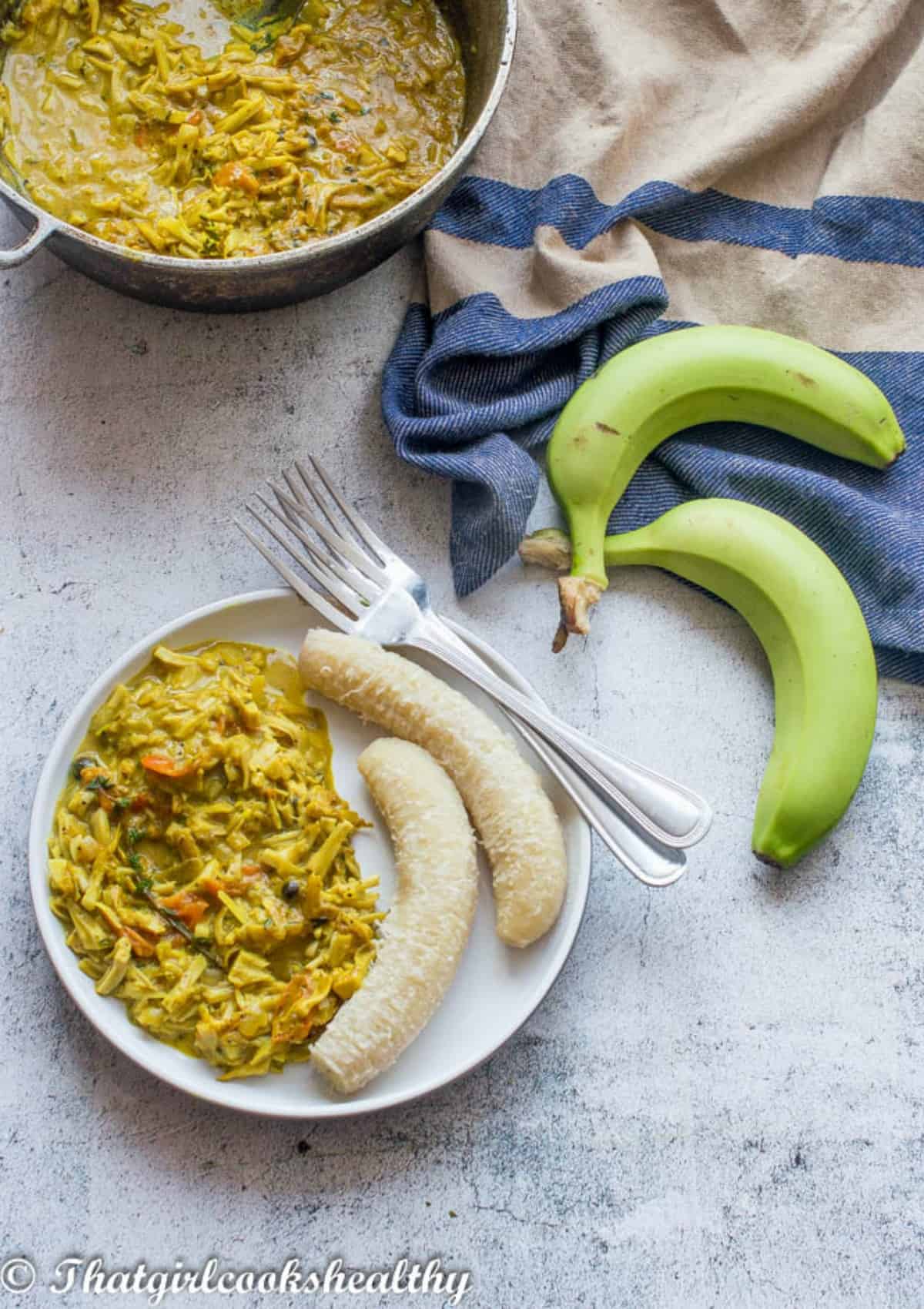 plate of food with green bananas