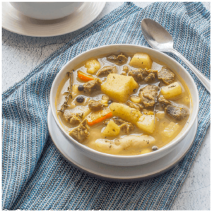 soup with mutton and vegetables in a white bowl