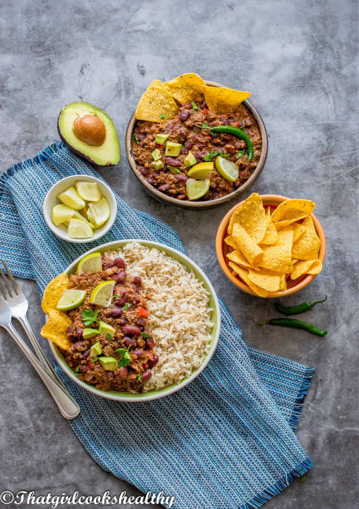 lamb with rice garnish with avocadoes and lime