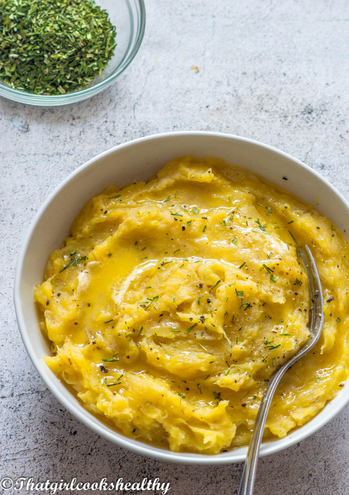 mashed plantain with fork in it