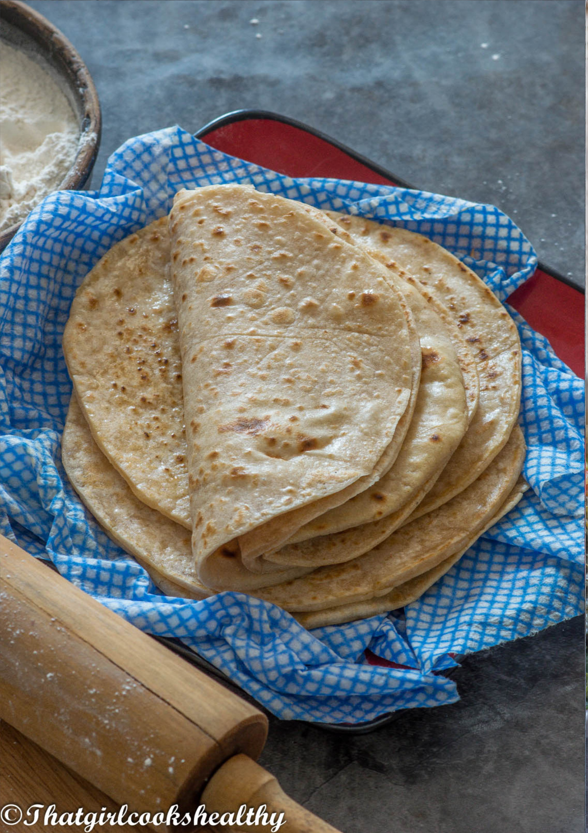 folded over roti on a damp cloth