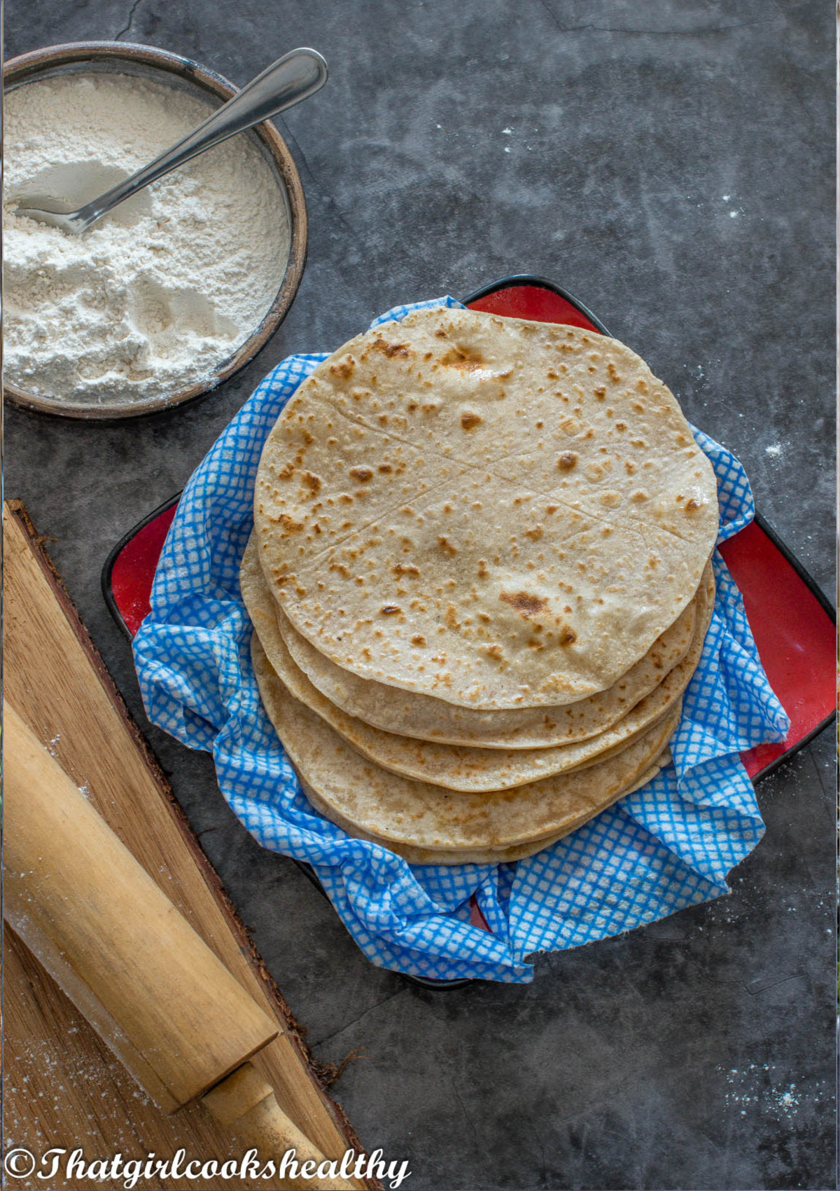 A plate of roti on a blue cloth