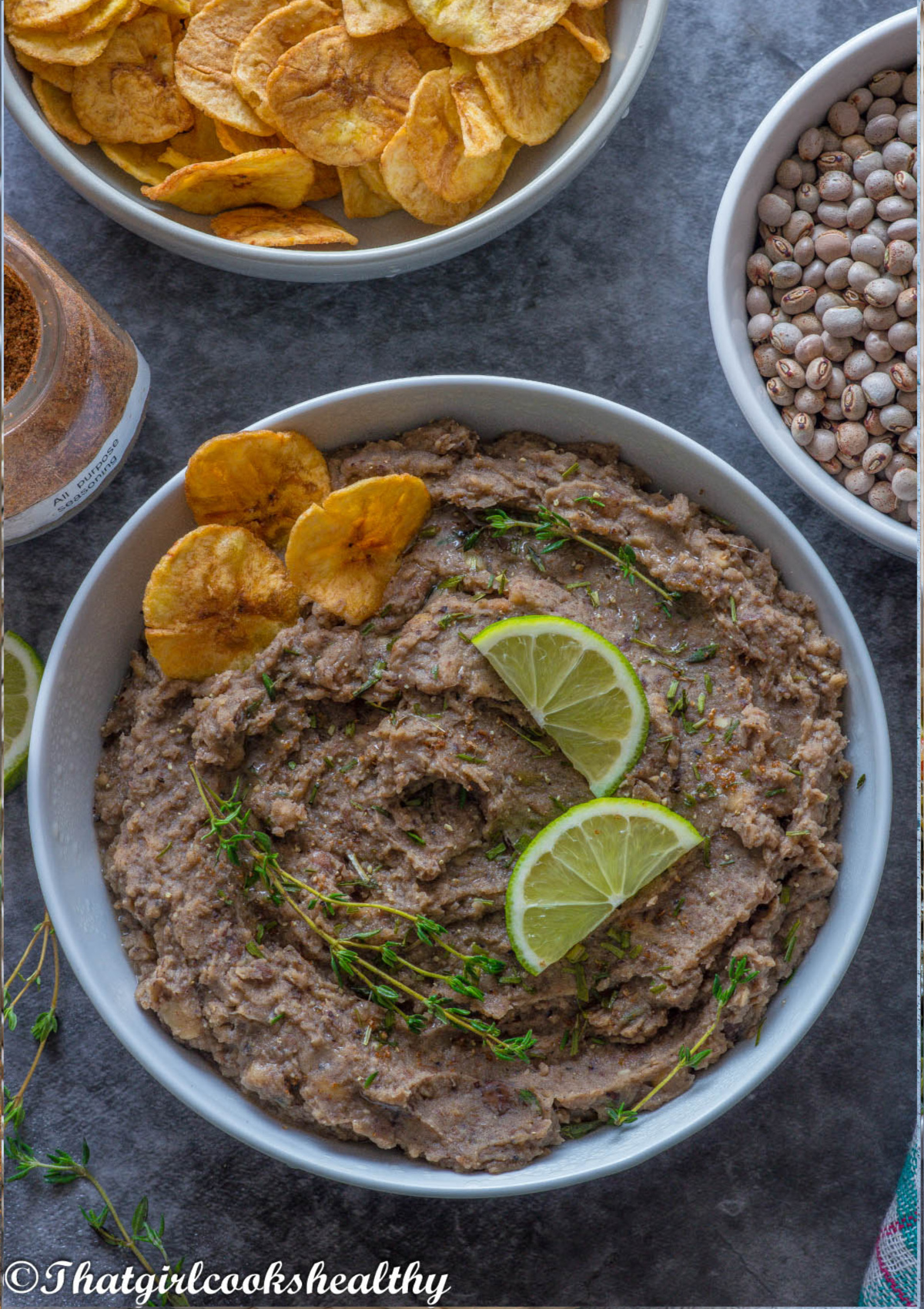 Refried gungo peas with garnish and plantain chips