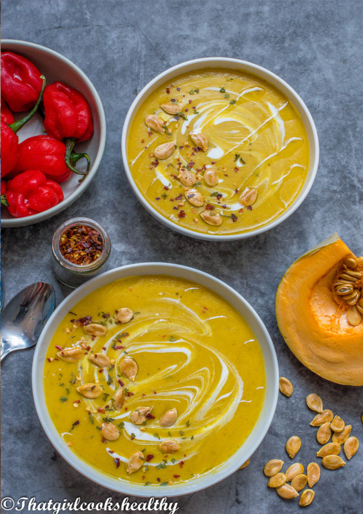 2 bowls of pumpkin soup with decor