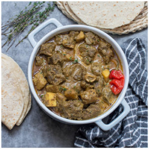 Curry goat in a casserole dish