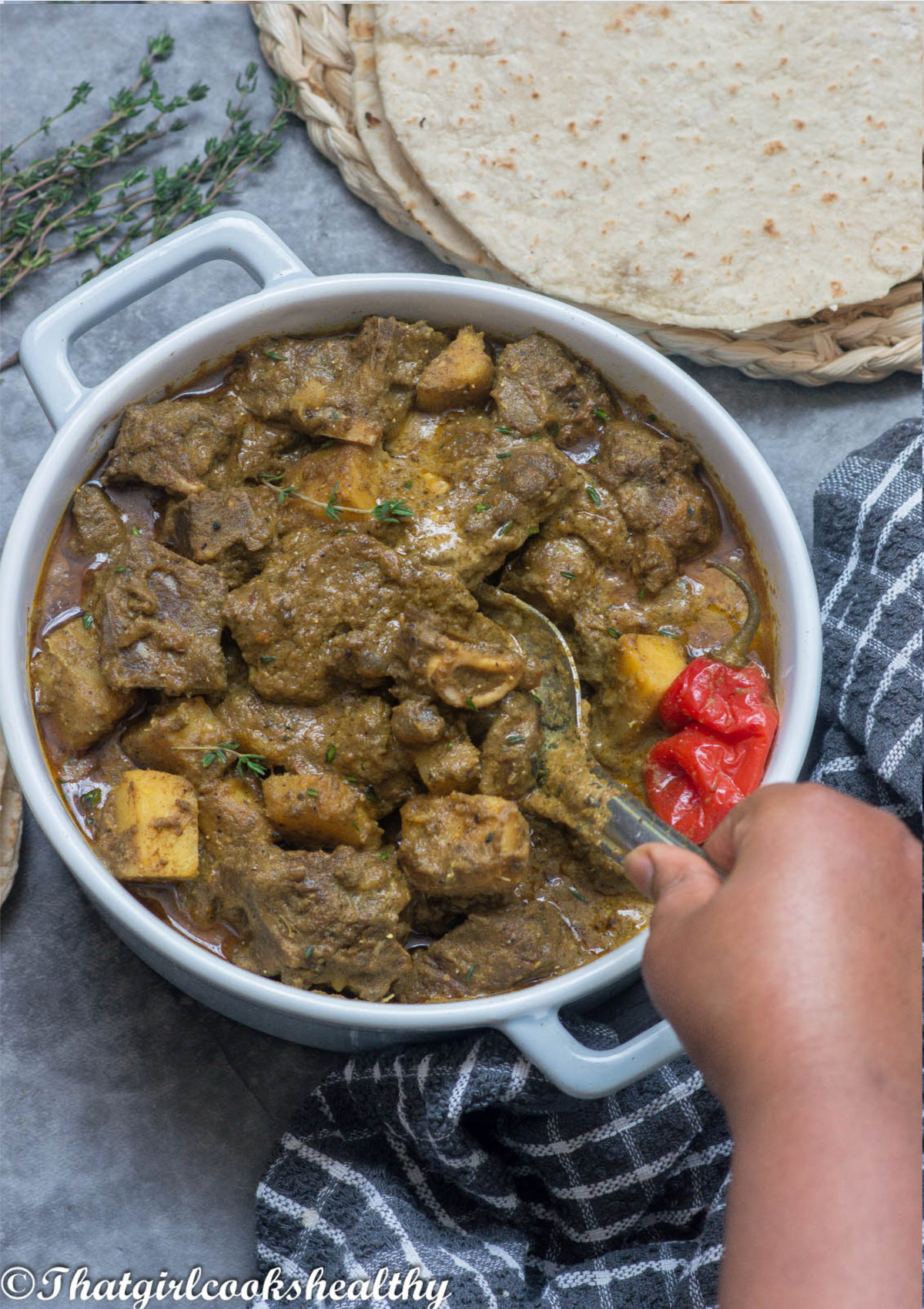 Spoon scooping up the goat meat