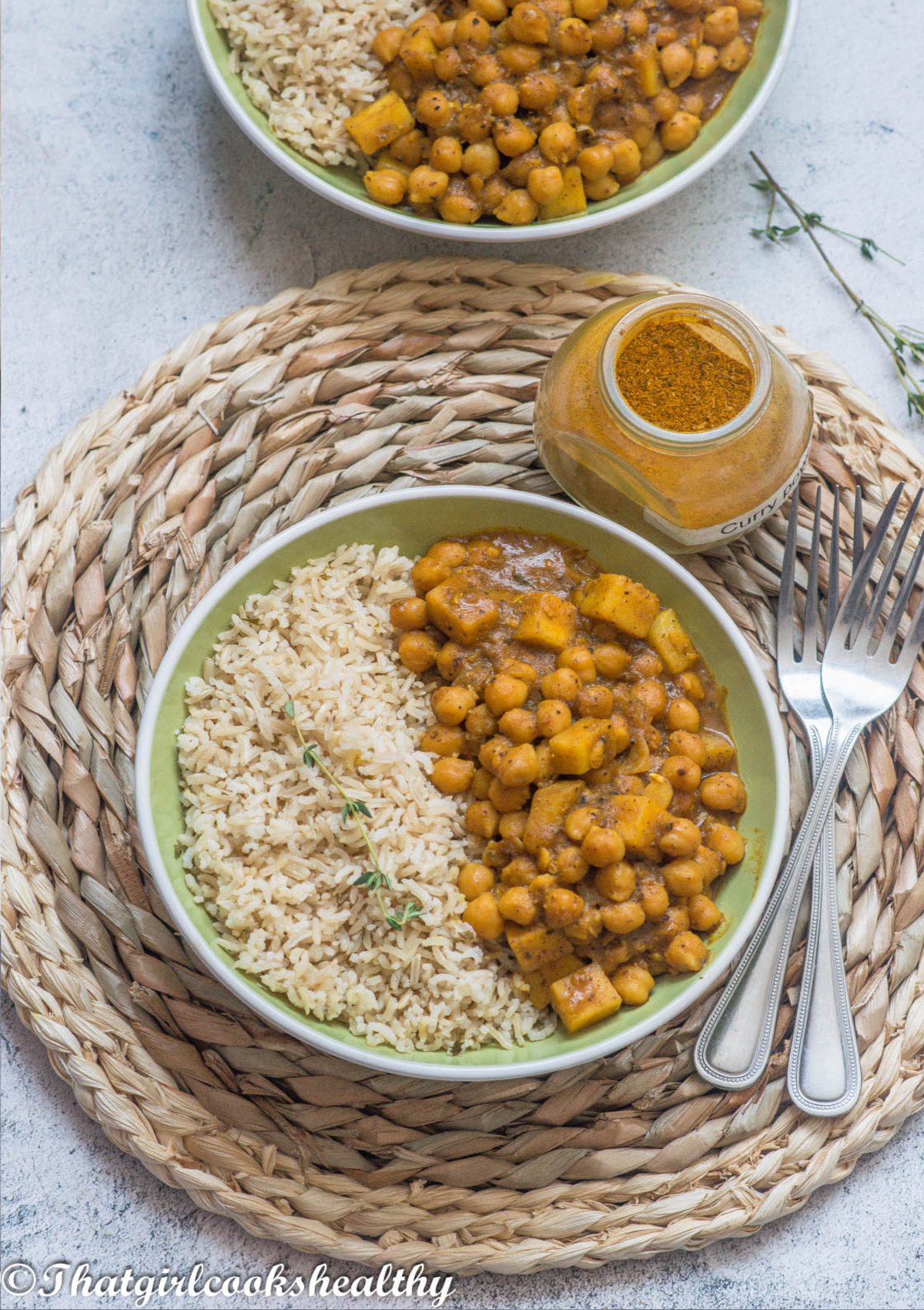 Overhead shot of the curried chickpeas with rice and 2 forks