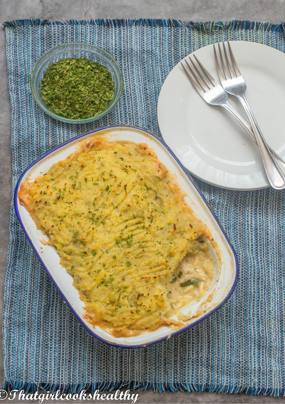 fish pie in a dish pie, partially exposed sauce