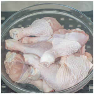 chicken legs in a clear bowl