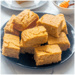 Cornbread slices on a black plate