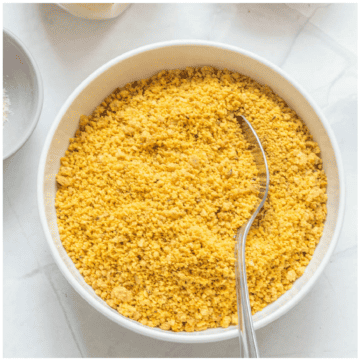 Spoon in a bowl of golden breadcrumbs