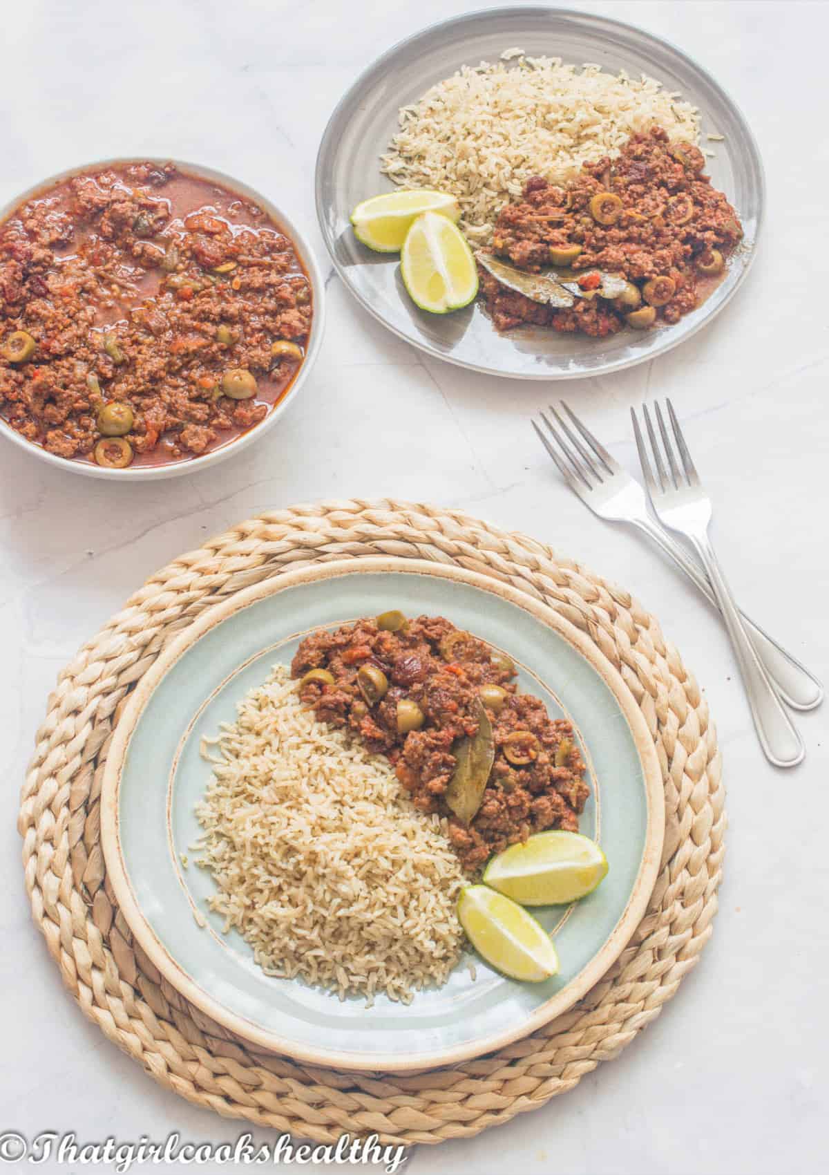 picadillo, brown rice and lime slices on a plate