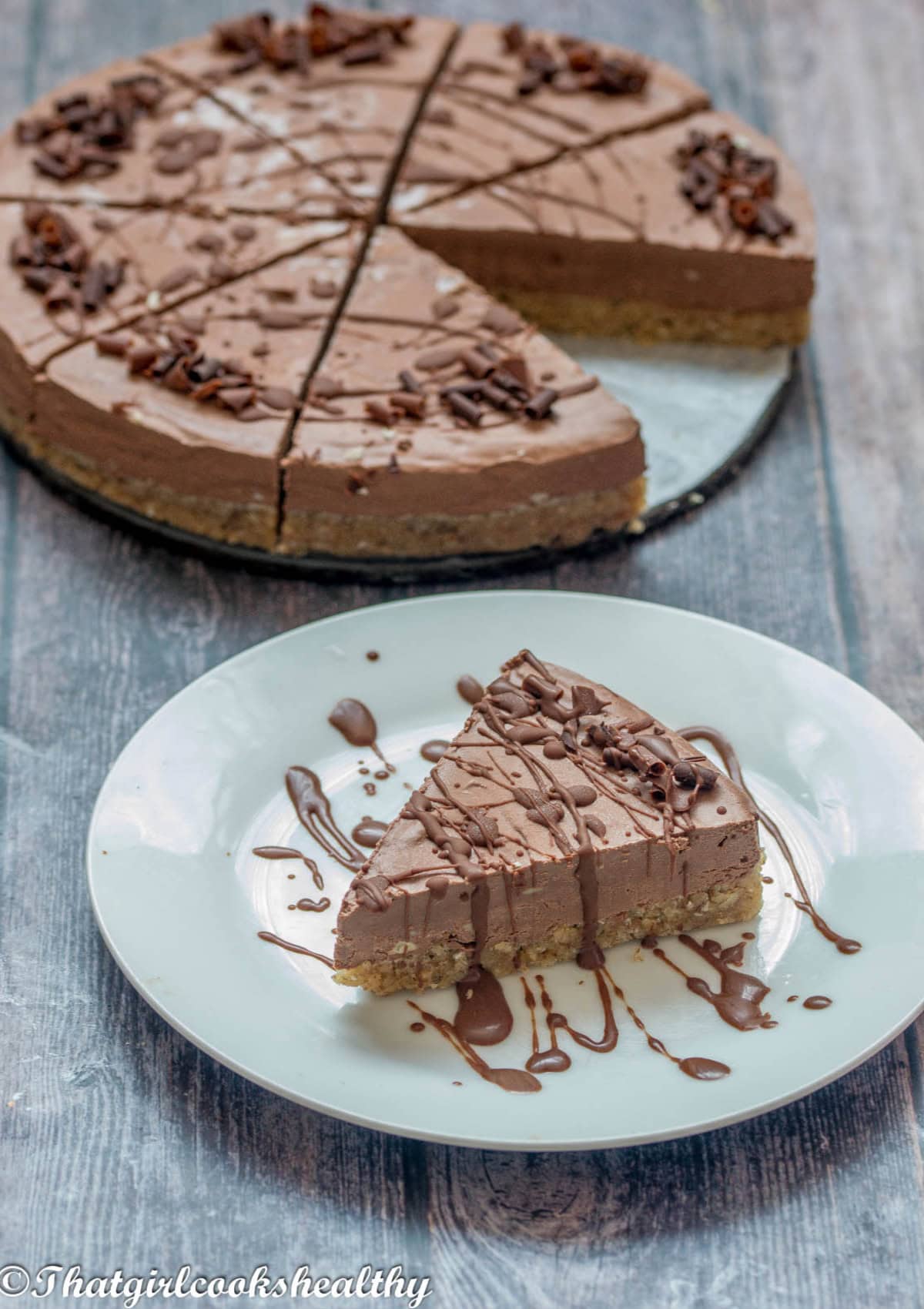 a portion of cheesecake with chocolate glaze