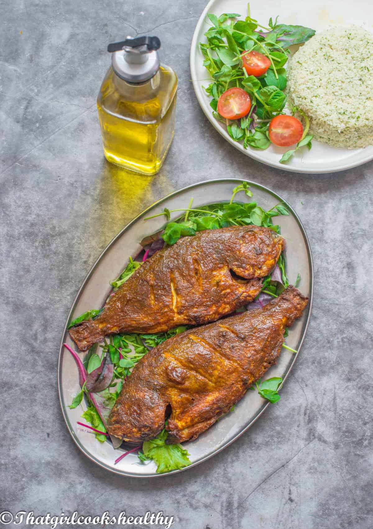 2 whole sea bream on a silver platter.