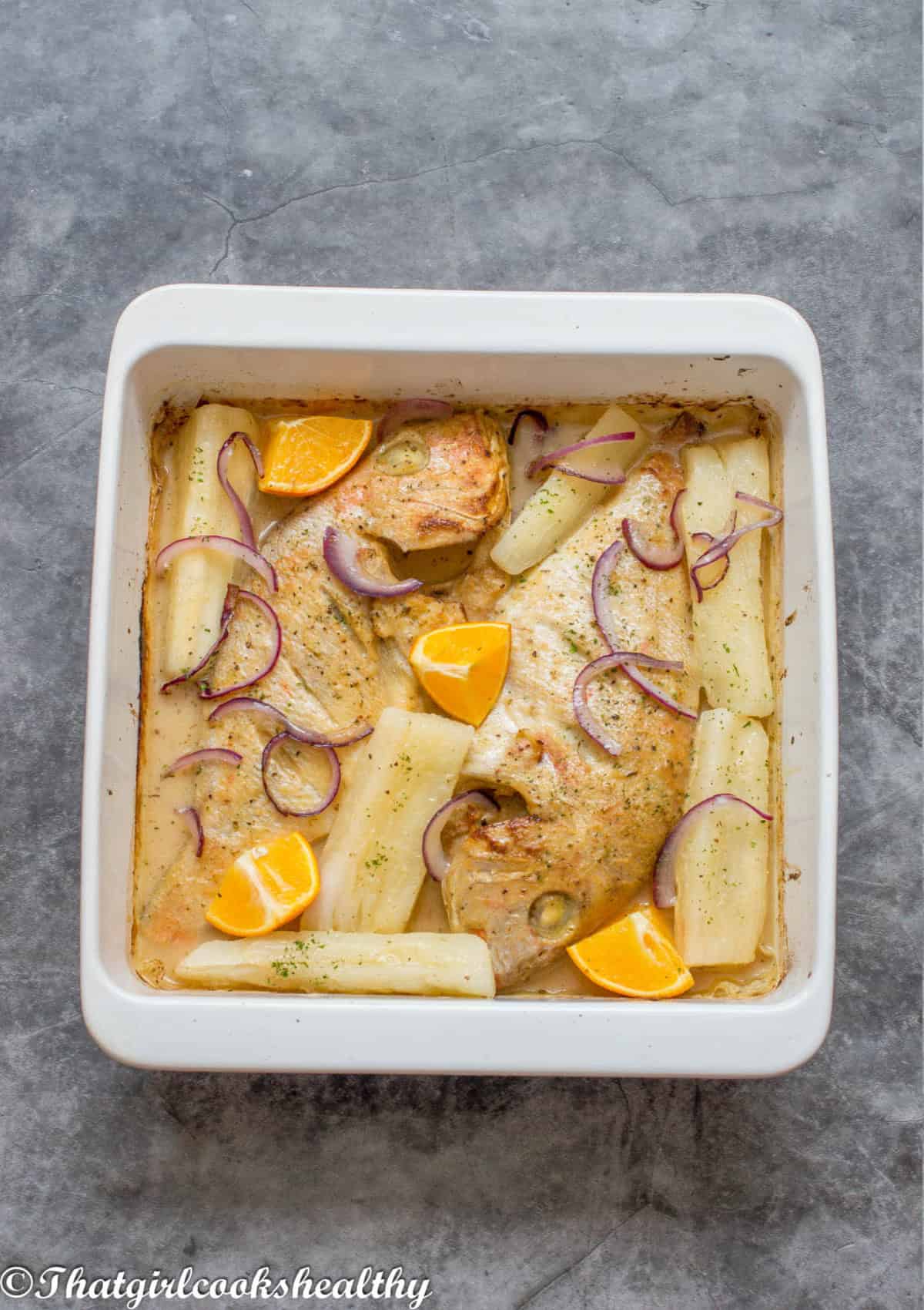 2 snapper with garnisehed with yuca and oranges