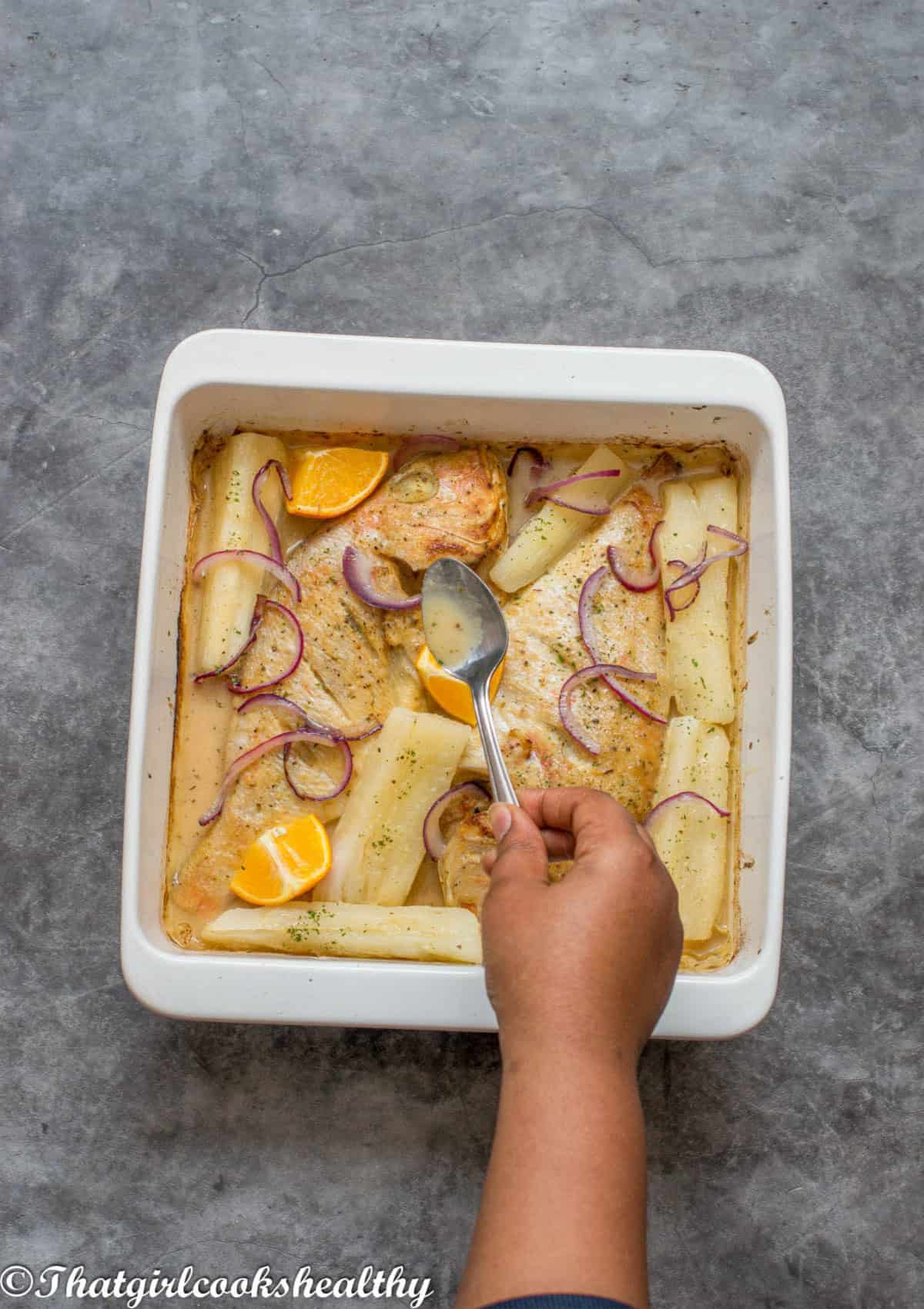 basting the snapper with the mojo sauce