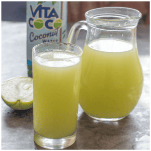 A pitcher of juice and a glass