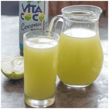 A pitcher of juice and a glass
