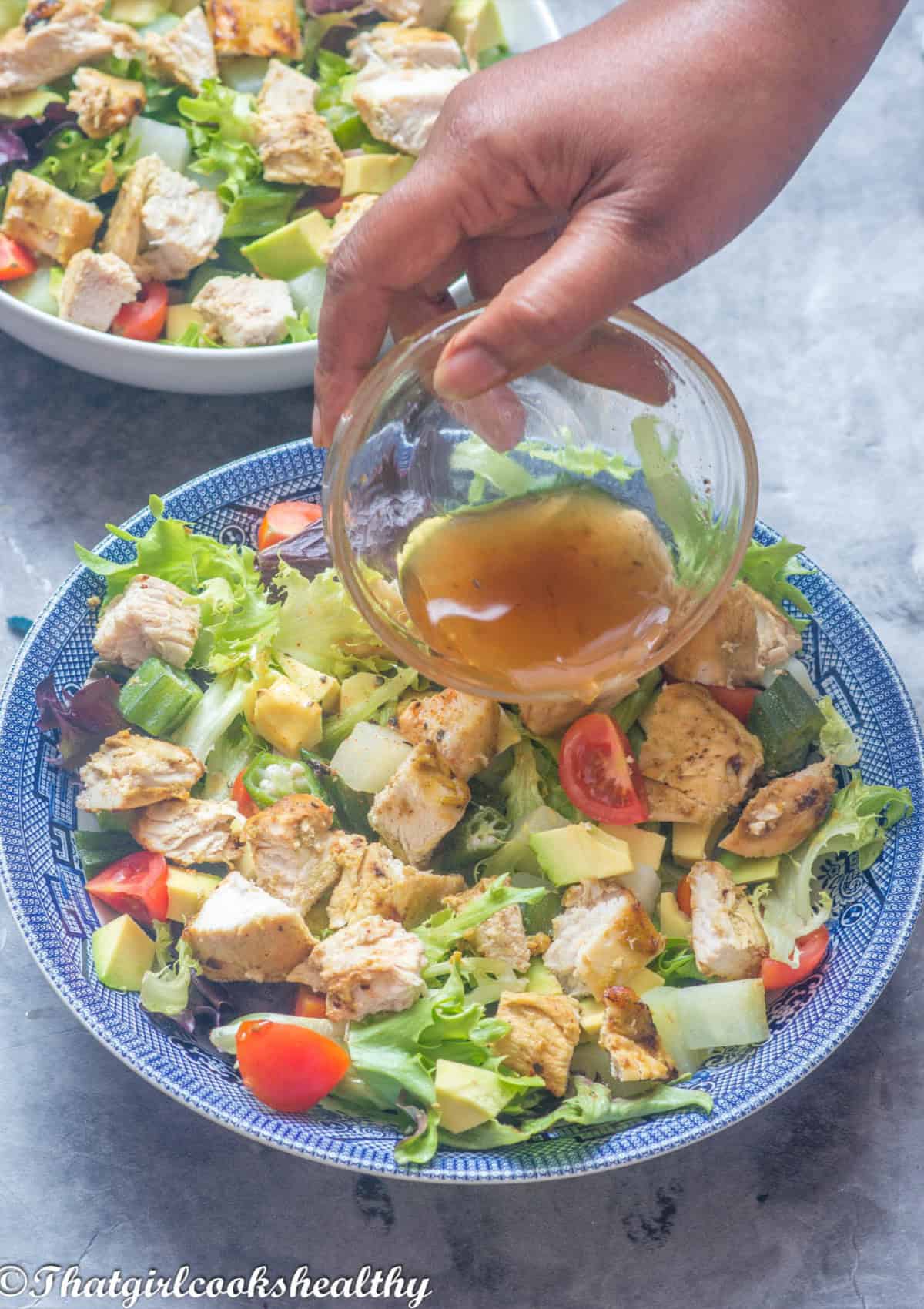 Pouring the dressing on the salad