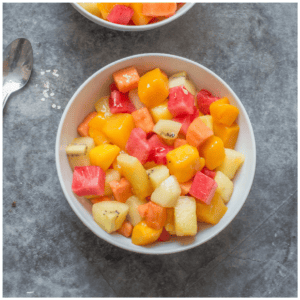 A bowl of different chopped fruit