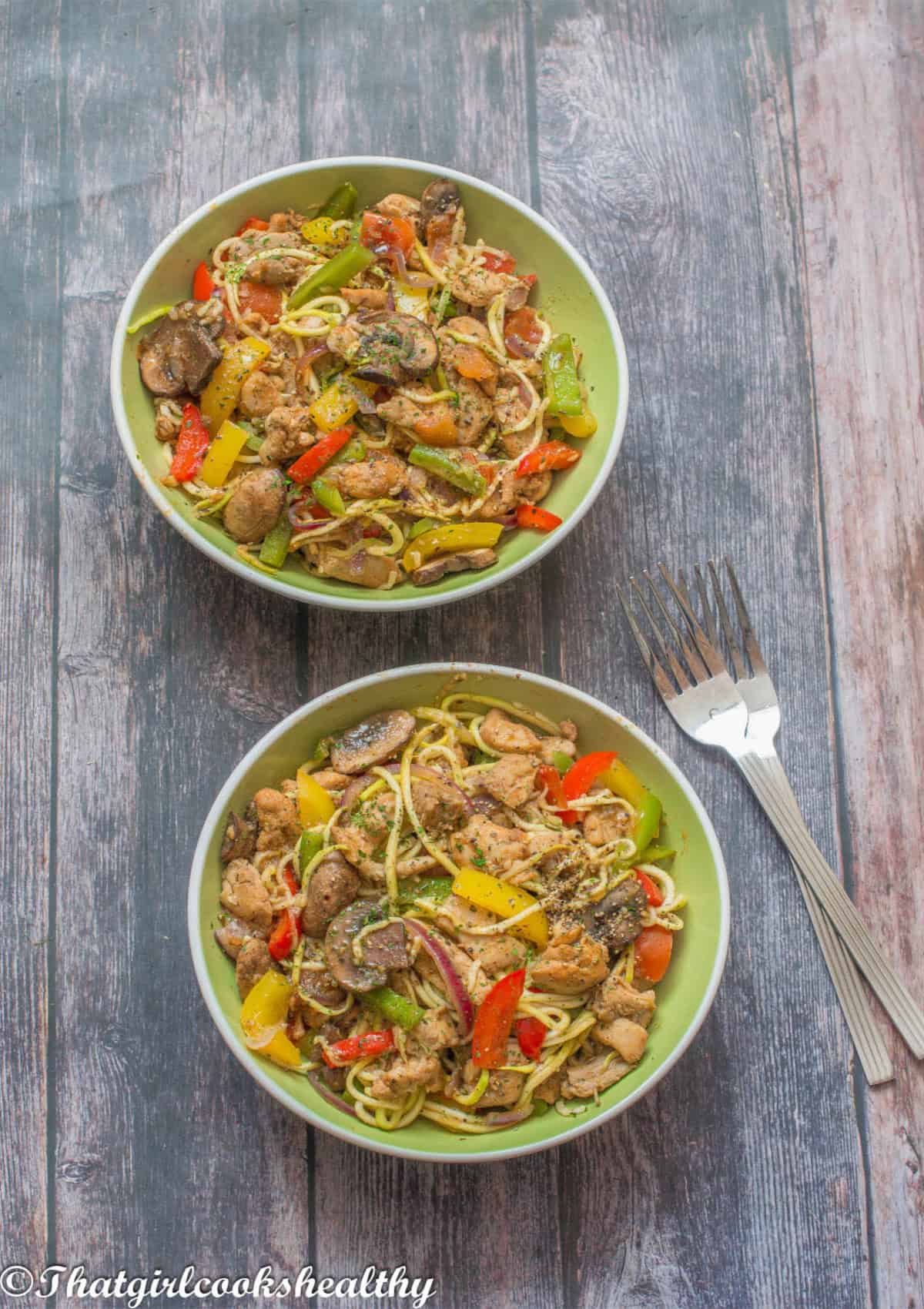 2 bowls of chicken with vegetables.