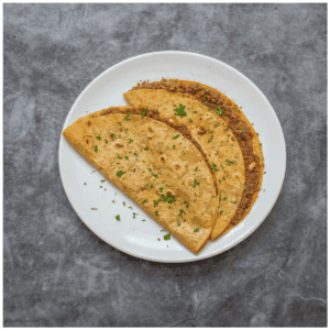 2 tacos garnished on a plate