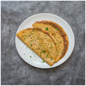 2 tacos garnished on a plate