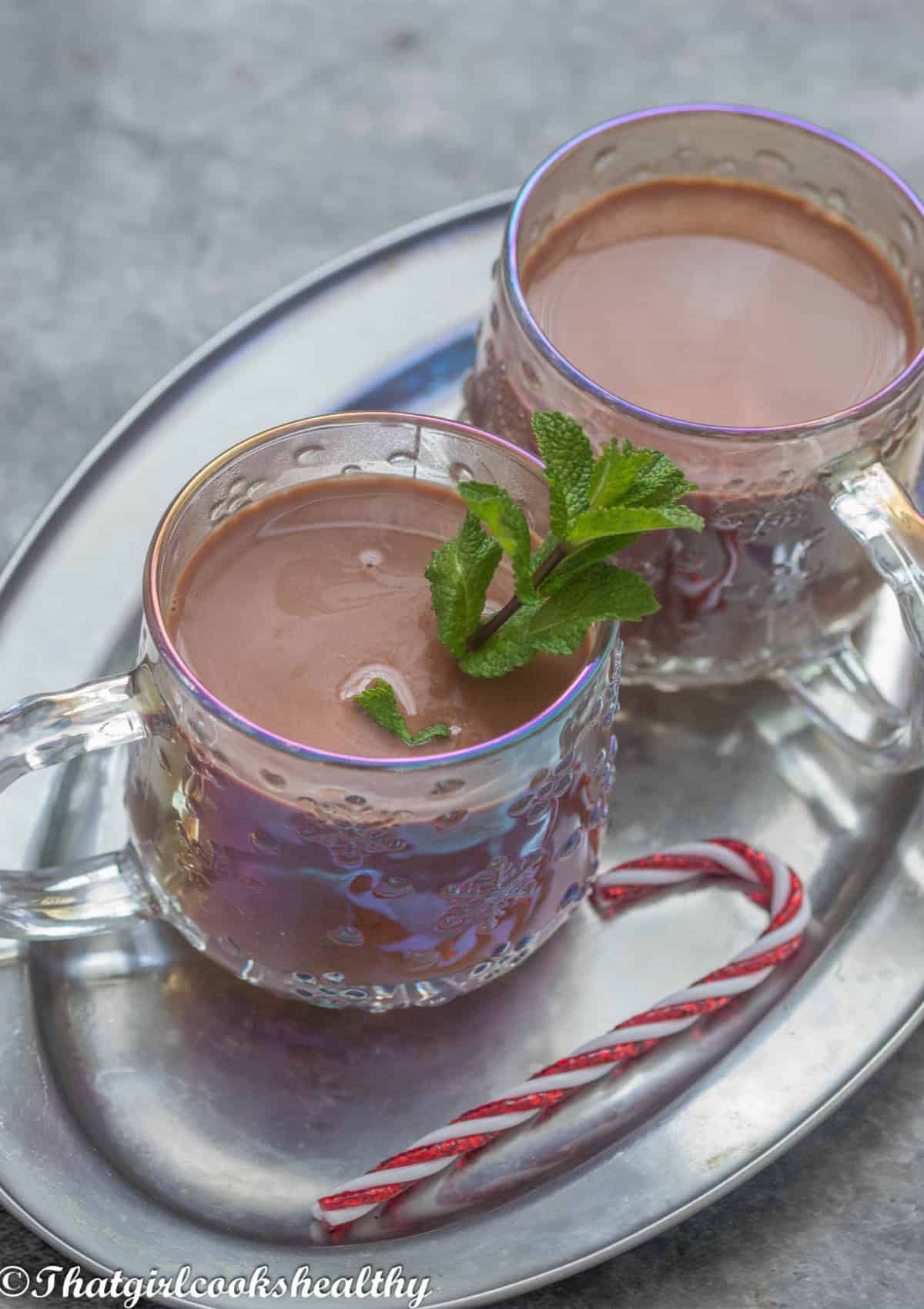2 mugs of hot chocolate with mint leaf