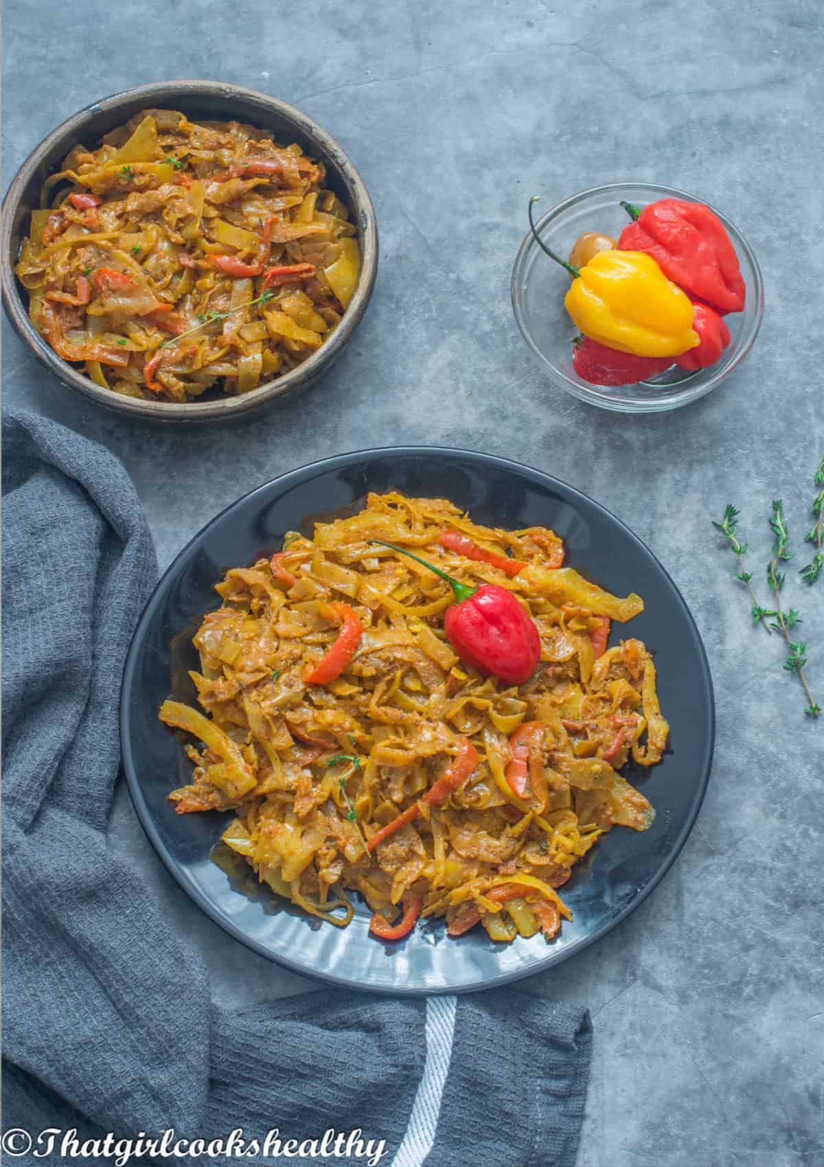 black plate with yellow cabbage with a small side bowl