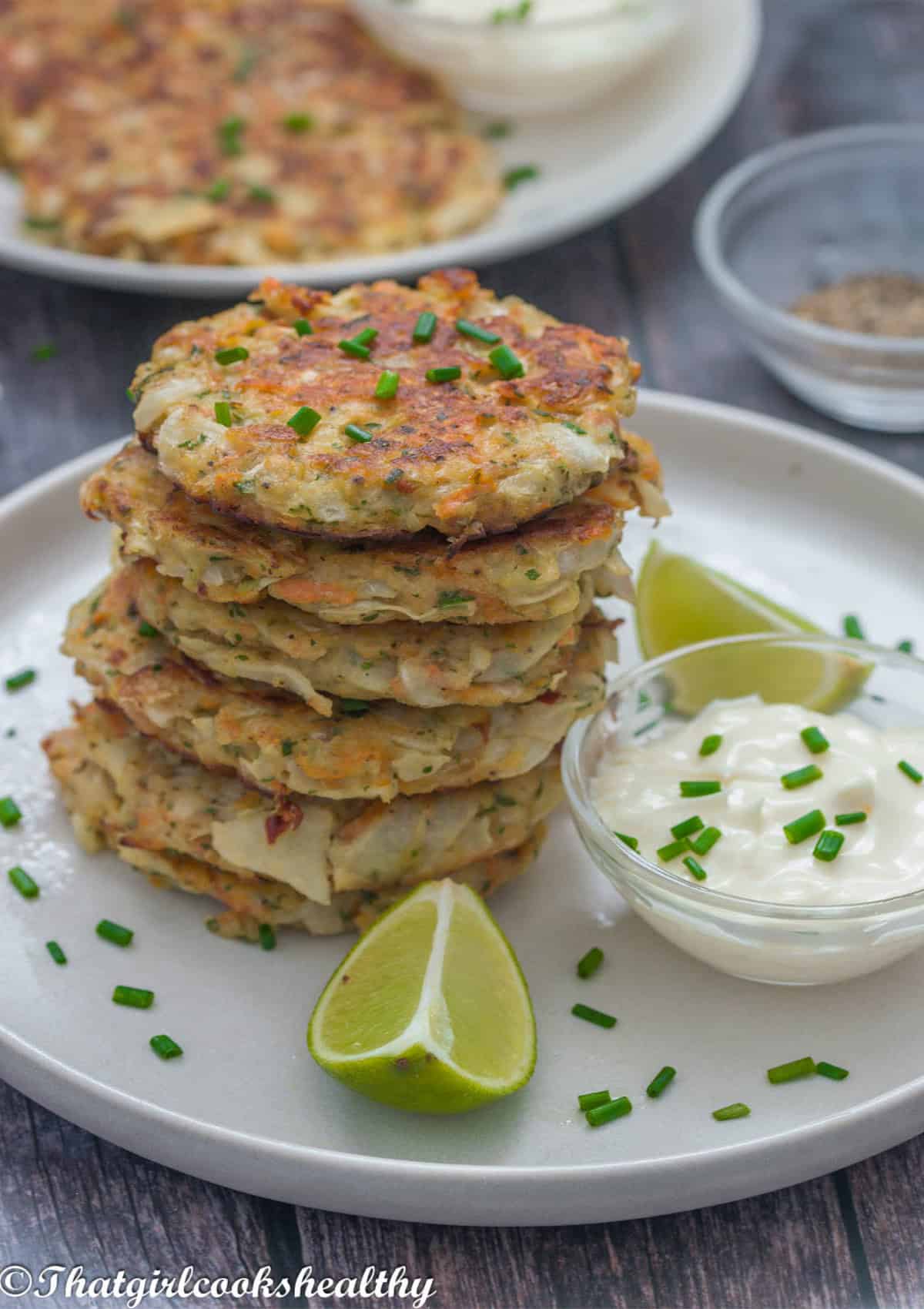 A stack of fritters with a dip