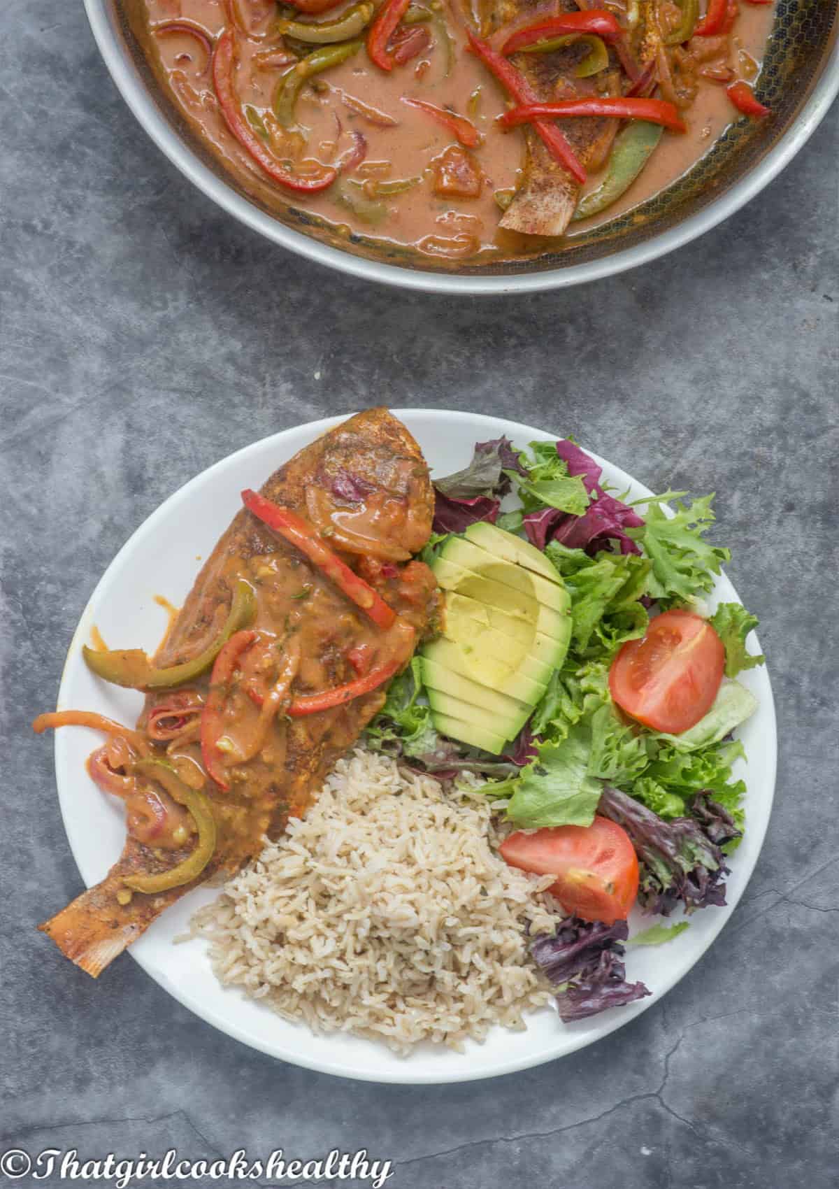 Fish, rice and salad on a plate