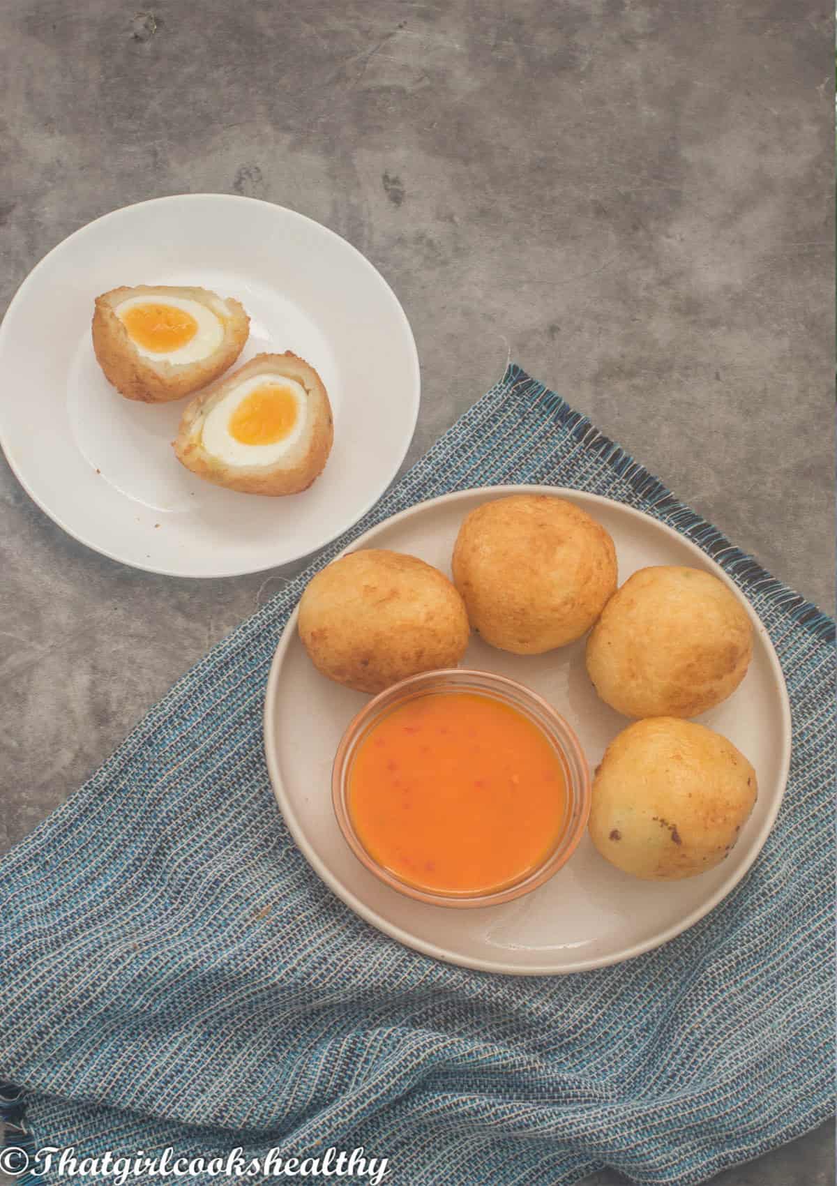 eggs halved and whole egg balls with dipping sauce