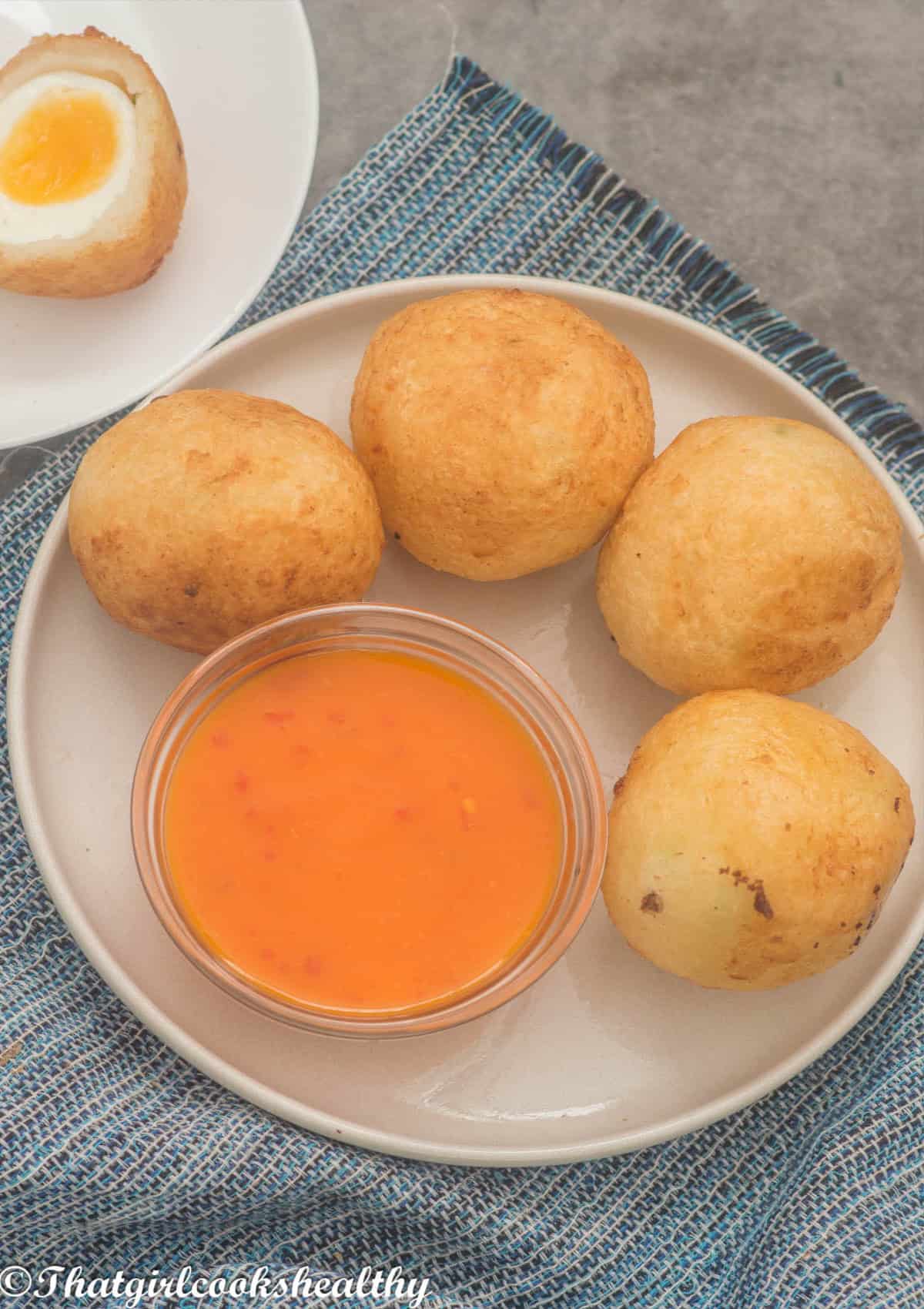 close up of the egg balls with dipping sauce