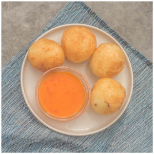 Egg balls in a side plate with dipping sauce