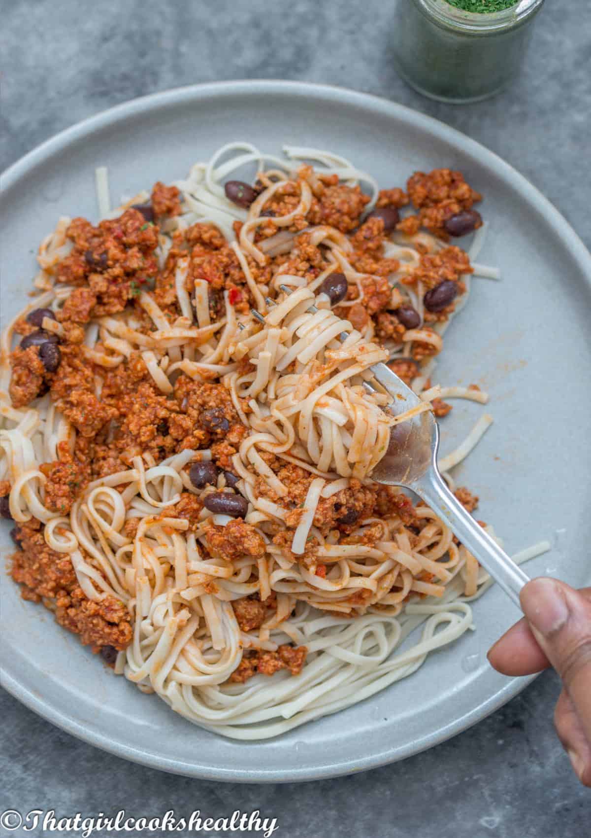 ground turkey with spaghetti with fork scooping up the food