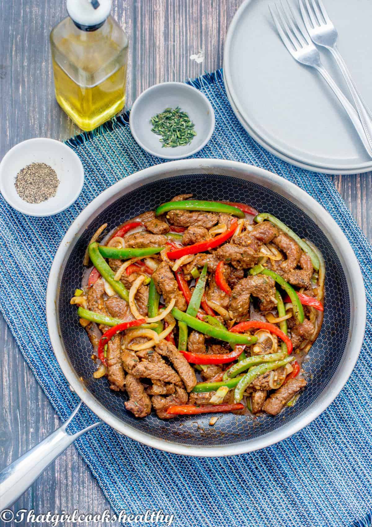 steak and bell peppers in a skillet