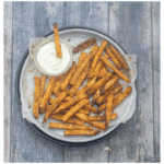 fries on a plate with dipping sauce