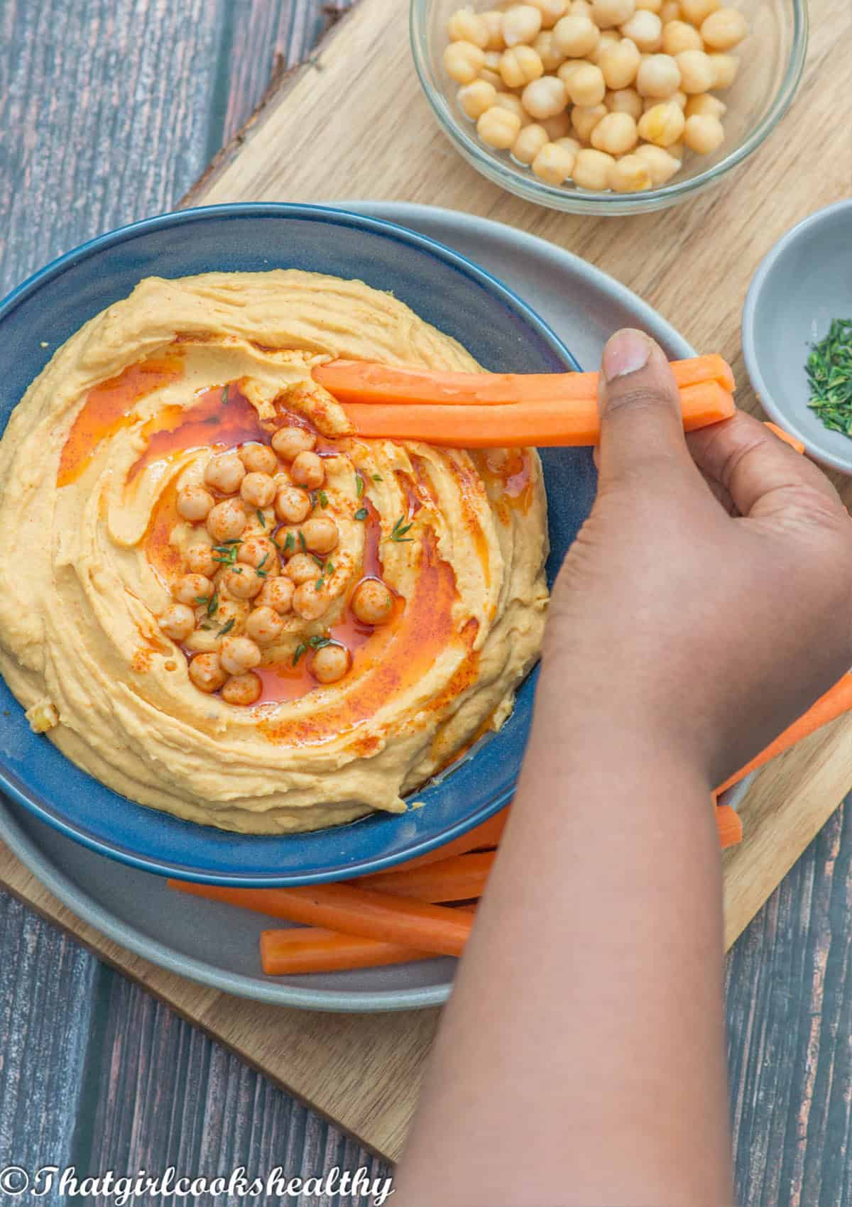 carrot scooping up the hummus