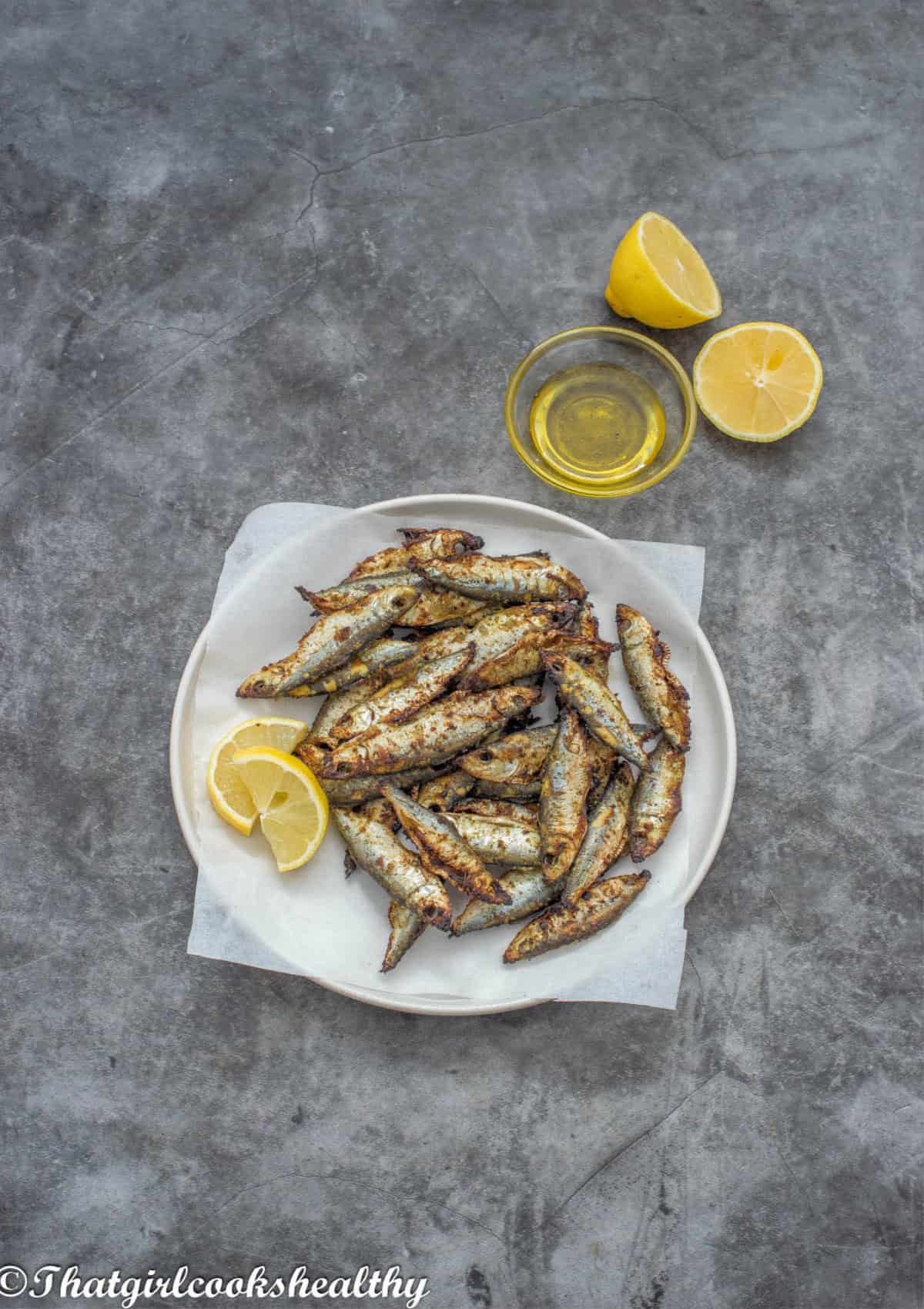 a plate of small fish with garnish