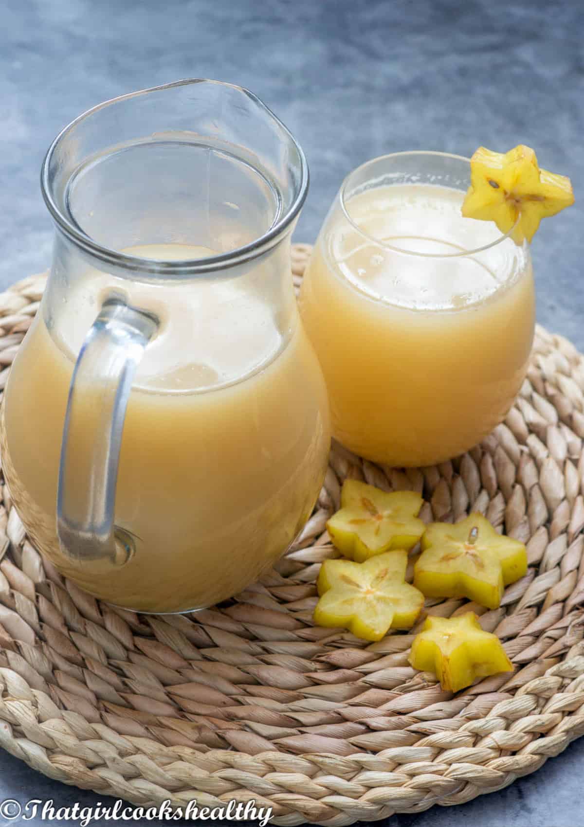 A jug and glass of starfruit juice
